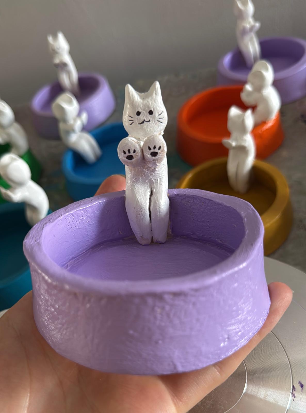 Hand-built pottery bowl with sculpted cat figure